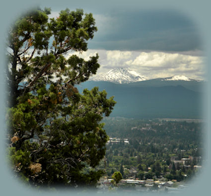 
bachelor butte photographed from atop pilot butte in bend, oregon, central oregon's gateway: find alpine lakes, skiing, hiking trails, volcanoes, newberry national volcanic monument: benham falls, wild and scenic deschutes river, lava cast forest, lava river cave, lava butte, lava lands, paulina and east lakes, newberry crater; lapine state park, and more